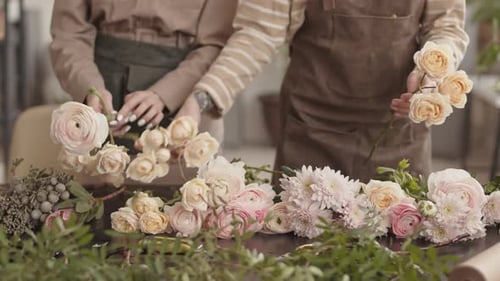 Florists Arrange Pink Flowers at a Flower Shop