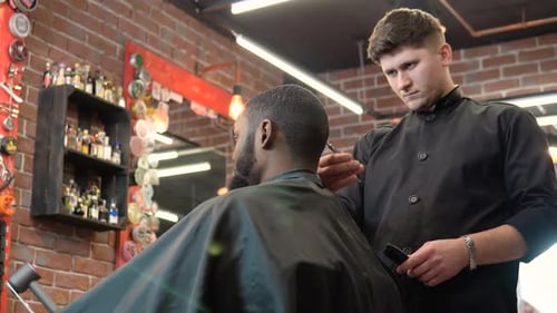 Barber Trims Client's Hair in a Modern Shop