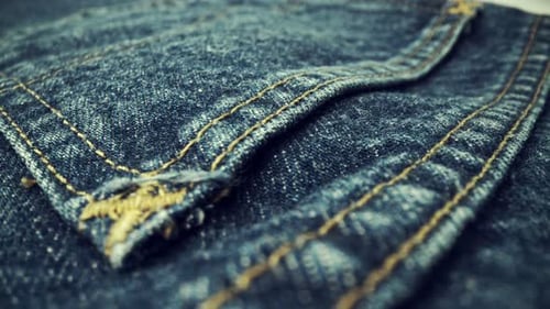 Close Up of Textured Denim with Yellow Stitching