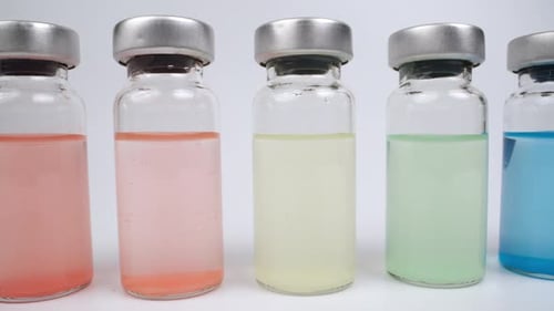 Various Colorful Liquids in Medical Glass Vials