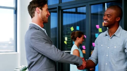 Businessmen Handshake in Bright, Modern Office