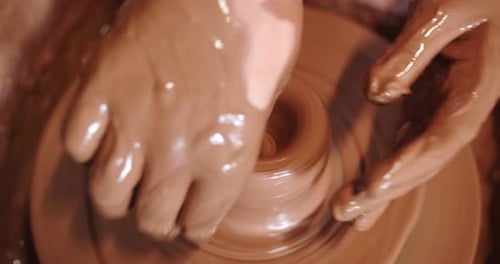 Hands Shaping Clay on Potter's Wheel, Close Up