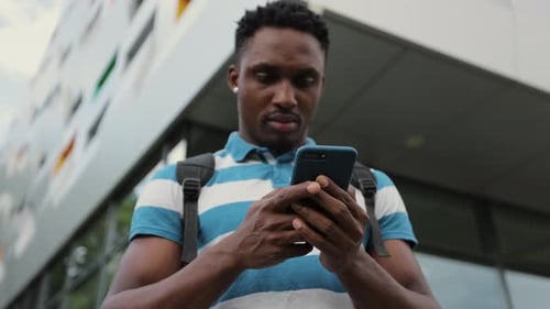 Young Adult Using Mobile Device in Urban Setting