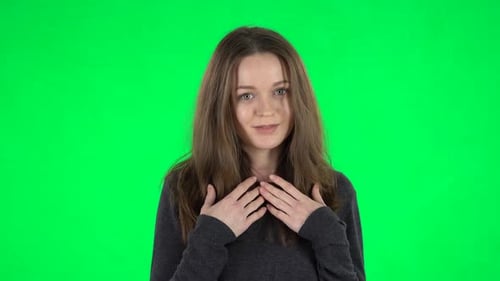 Woman Explaining and Gesturing on Green Background