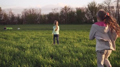 Lovely Kids Couple Running on a Grass Field