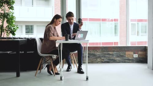 Business Colleagues Working Together on Laptop in Office