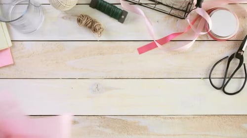 Hands Arranging Pink Tulips on Craft Table