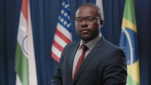 Formally Dressed Adult in front of Flags
