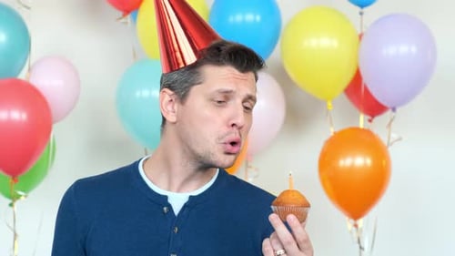 Sad Man Holding a Birthday Cupcake