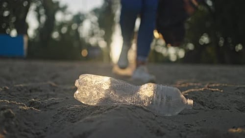 Discarded Plastic Bottle Picked Up on Beach