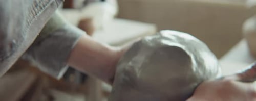 Hands Shaping and Sculpting Clay Art in Studio