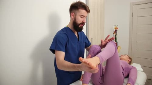 Healthcare Provider Assists Patient with Leg Examination