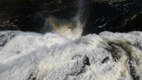 Aerial View of Powerful Waterfall with Rainbow