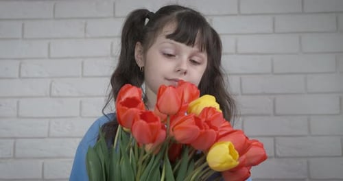Young Girl Holding Tulips Inside