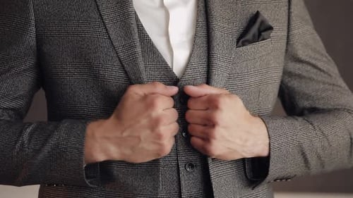 Buttoning Jacket with Hands Close Up Man in Suit Fastens Buttons on His Jacket Preparing to Go Out