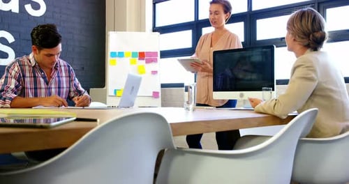 Office Workers Collaborating Around a Conference Table