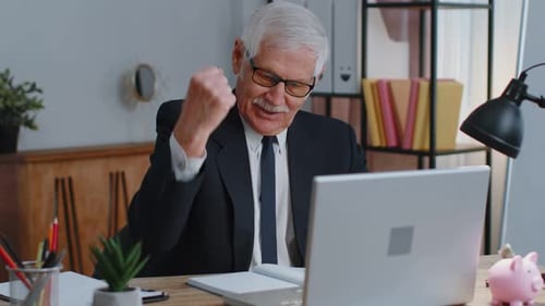 Senior Business Office Man Analyzes Financial Charts Celebrate Success Win at Home Workplace Desk
