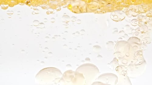 Oil Bubbles Rising in a Clear Liquid