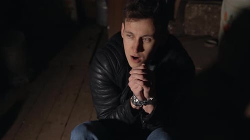 Man in a Dark Room with Blindfolded Hands. Hostage