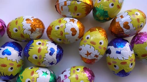 Colorful Easter Eggs with Chick Designs on Table
