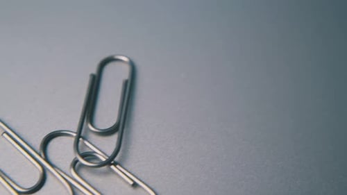 Silver Paper Clips on Grey Surface