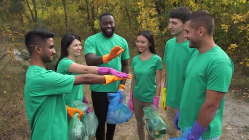 Group of Happy Volunteers Cleaning Up Litter in Nature