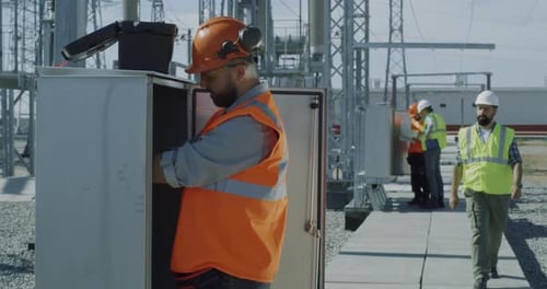Engineers Work at Electrical Power Station