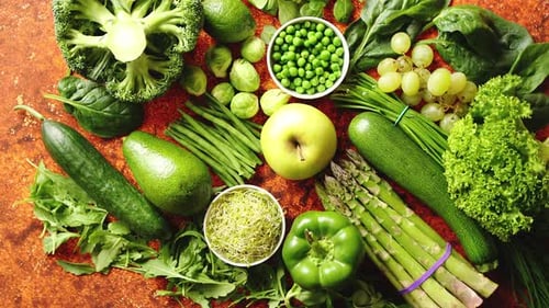 Fresh Green Vegetables and Fruits Assortment Placed on a Rusty Metal