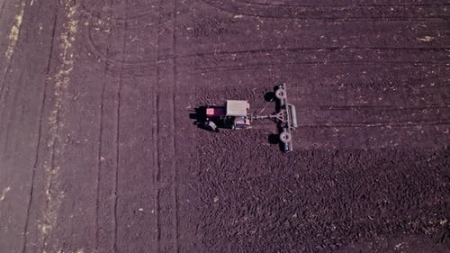 Tractor Tilling Center of Farm Field in the Fall
