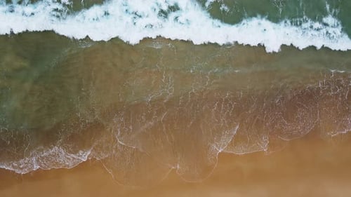 Aerial view of white sand beach and ocean wave