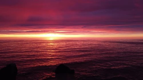 Beautiful aerial vibrant high contrast pink purple sunset over Baltic sea, Karosta war port concrete