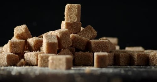The Brown Sugar Cubes Rotate Slowly on the Table
