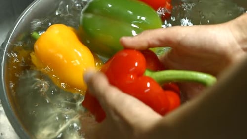 Washing Colorful Fresh Bell Peppers in Water