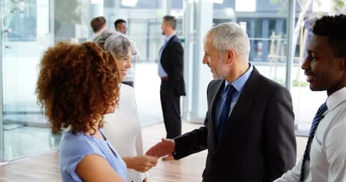 Businesspeople shaking hands in office