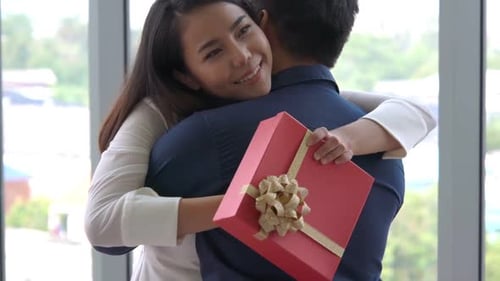Romantic Couple Giving Gift to Lover at Restaurant