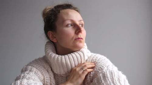 Worried Woman with Hair in Bun Close Up