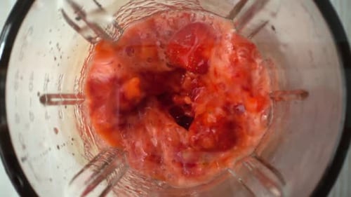 Strawberries Being Blended Into Smoothie