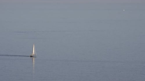 A Small Blue Yacht on the Sea Surface