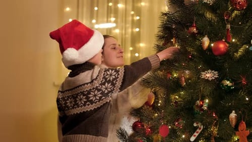 Happy Smiling Family Preparing for Christmas and Decorating Christmas Tree with Traditional Toys