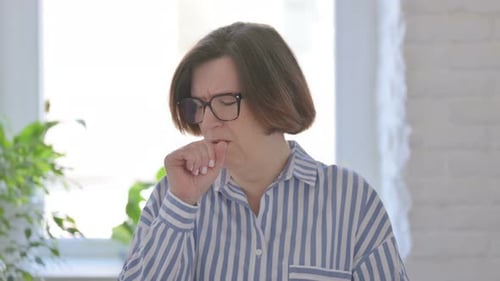 Woman Coughing, Experiencing Chest Discomfort Indoors