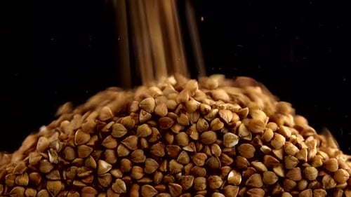 Poured Buckwheat Kernels Accumulate, Close Up Food Stock