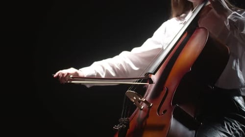 Female Hands Playing Cello on Black Background Closeup Side View Studio Shooting