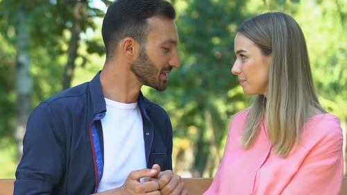 Man and Woman in Love Admiring Each Other Sitting on Bench in Park, Romance