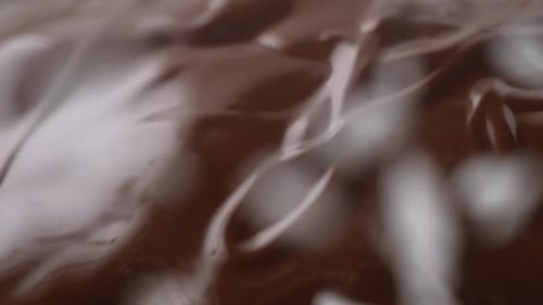 Sprinkling shredded coconut on chocolate. Slow Motion.