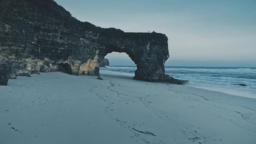 Cold Light Blue Beach at Ocean Bay Waves Aerial View. Natural Landmark at Seascape with Rock Wall