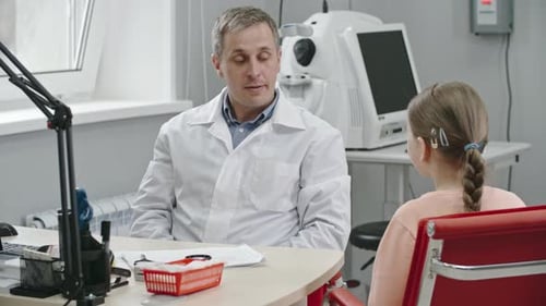 Doctor Talking With Girl in Medical Office