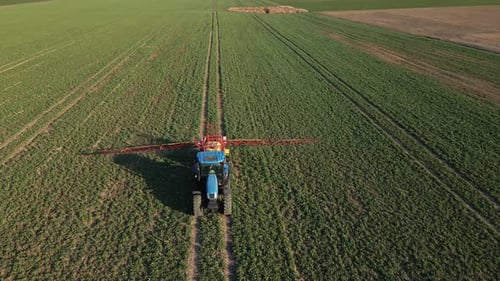 Tractor Spray Fertilizer on Agricultural Field Aerial View