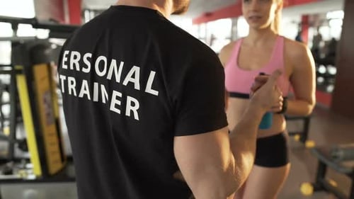 Conversation Between Personal Trainer and His Female Trainee in Gym on a Break
