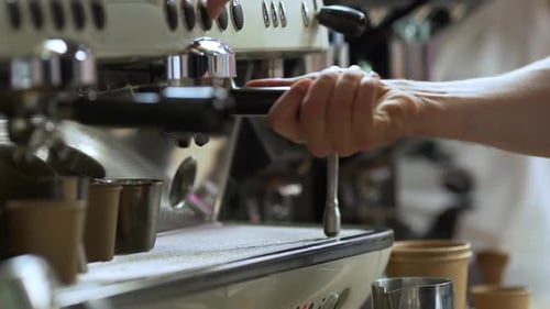 Close Up Shoot of Barista Making Espresso Using Coffee Machine Putting Two Paper Cups for Caffeine