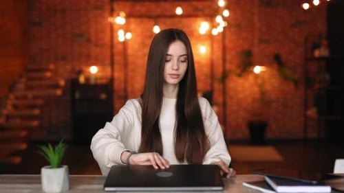Woman Opens Laptop in Home Interior